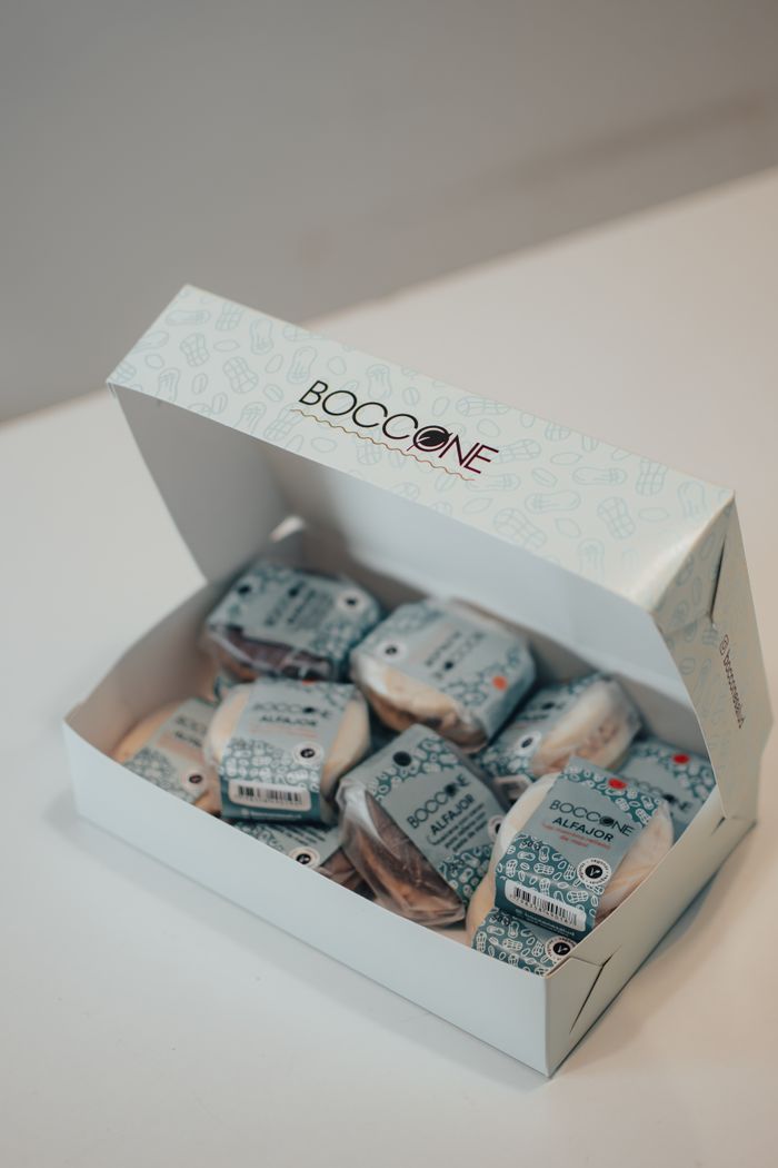 Open box containing Boccone packaged sweets, placed on a white background with a focus on branding.